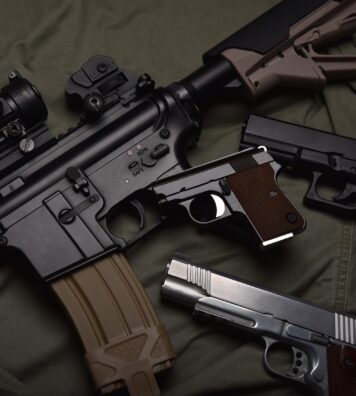 Weapons and military equipment for army, Assault rifle gun (M4A1) and pistol on green military uniform background.