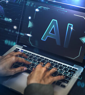 Businessman typing AI on the laptop screen