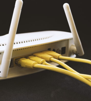 Yellow network cables connected in a white modem.